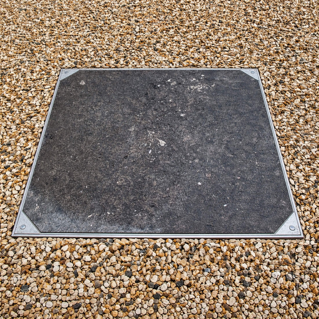 Sealed and Locking Recessed Cover in a Flag and Pebble Pathway